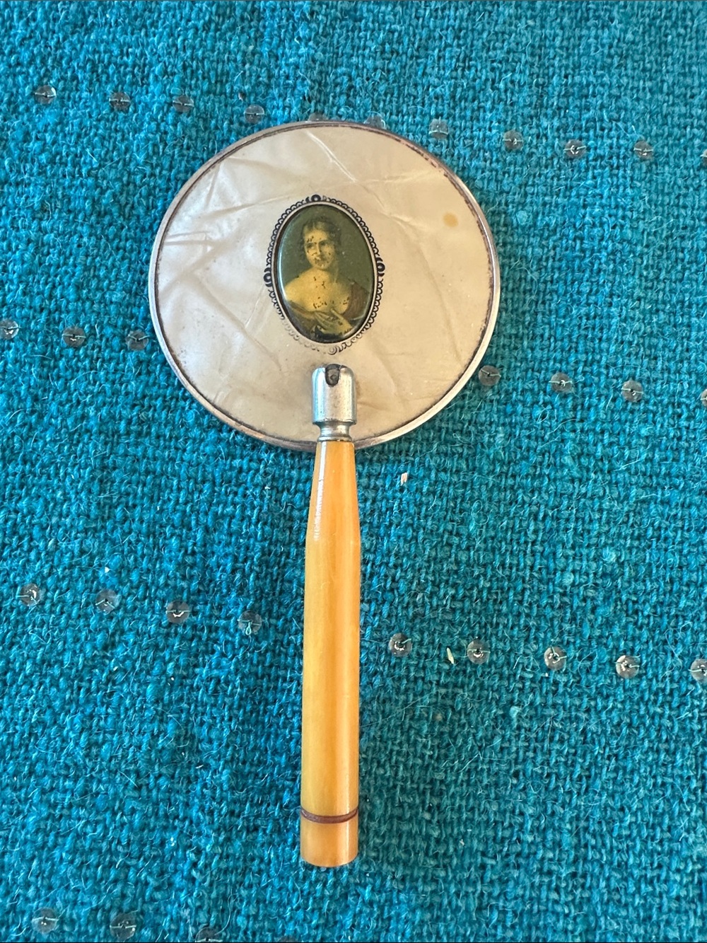 Vintage Hand Mirror with Portrait Accent and swiveling Bakelite handle